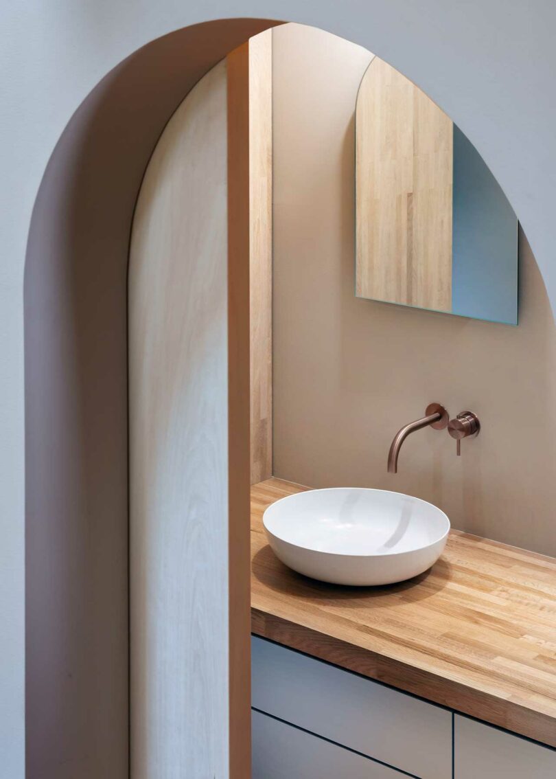 partial view into bathroom through arched doorway