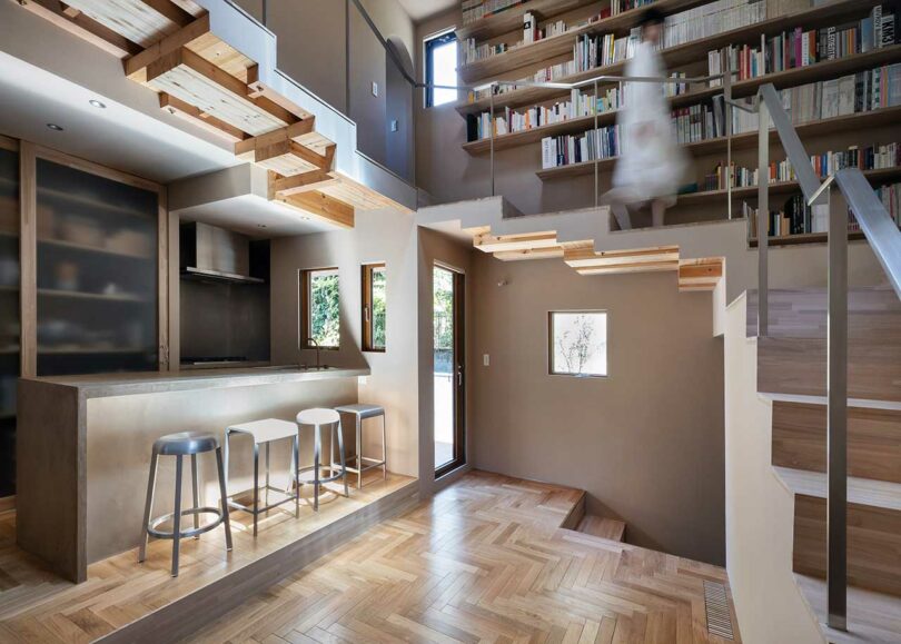 angled interior view of modern home with stairs lining perimeter of open living space